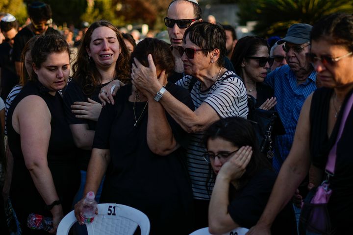 Family and friends mourn during the funeral of Maya Puder in Zikhron Ya'akov, northern Israel, on Thursday. Puder was among hundreds of people killed by Hamas militants last week at a music event near Re'im.
