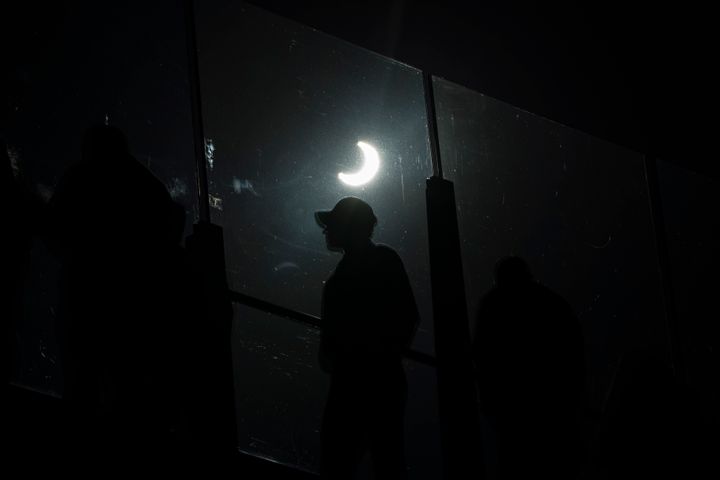 People watch a rare "ring of fire" solar eclipse along the Las Vegas Strip, Saturday, Oct. 14, 2023, in Las Vegas. (AP Photo/John Locher)