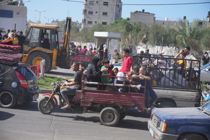 Palestinians flee to the southern Gaza Strip after the Israeli army issued an evacuation warning to a population of over 1 million in northern Gaza and Gaza City to seek refuge in the south ahead of a possible Israeli ground invasion, Friday, Oct. 13, 2023. (AP Photo/Hatem Moussa)