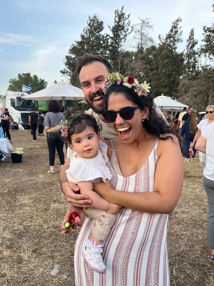 Ariel Golan and Dr. Elai Hogeg hold their daughter, Yael. All three residents of Kfar Azza were severely burned in the Hamas attack and are in induced comas.