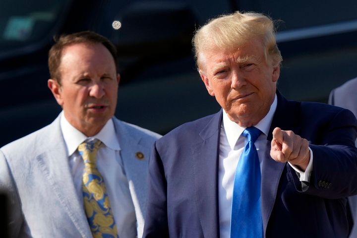 Former President Donald Trump arrives at New Orleans International Airport in New Orleans, Tuesday, July 25, 2023, accompanied by Louisiana Attorney General Jeff Landry, left. (AP Photo/Gerald Herbert)